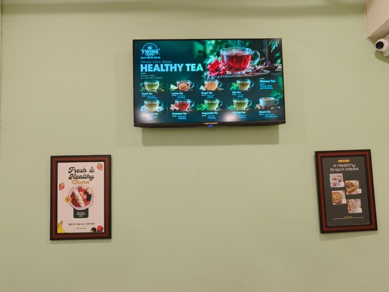 Digital menu screen showing Healthy Tea on the wall at Twing Cafe Rajkot